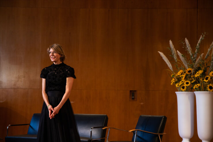 Skådespelerskan Cecilia Frode står på en scen. Hon har ett headset på sig.